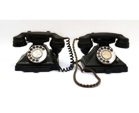 A near pair of Bakelite telephones,20th century, having corded receivers and manual dials,24cm wide13.5cm deep15cm high (2)Tw