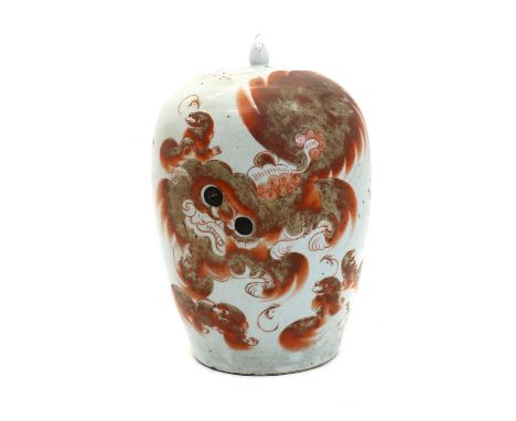 A Chinese iron-red jar and cover,Republic period (1912-1949), of tapering form, painted with a Buddhist lion and pups, inscri