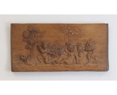 A carved wooden plaque,early 20th century, depicting cherubs cavorting, signed 'F R Louis' and dated '1915', inscribed to the