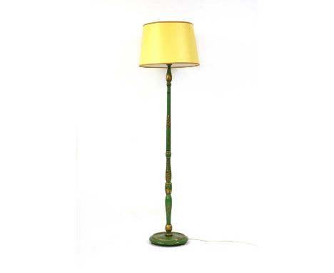 A green lacquered Chinoisiserie standard lamp,early 20th century, gilded with figures, with a yellow shade,160cm high to fitt