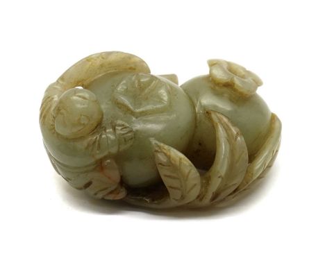 A Chinese jade carving,20th century, of a boy by the side of two pomegranates, 6.5cm longCondition ReportCracks to stone.