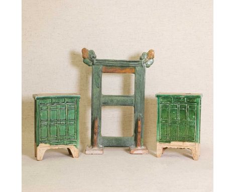 A pair of Chinese earthenware furniture models, Ming dynasty (1368-1644), in the form of two cabinets, covered under a green 