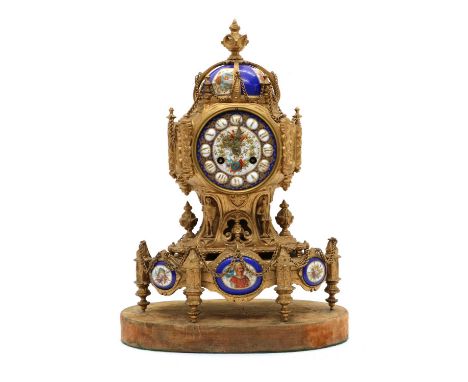 A French gilt spelter mantel clock,late 19th century, with applied painted porcelain mounts, the two train movement striking 