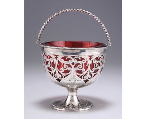 A VICTORIAN SILVER AND RUBY GLASS SUGAR BASKET by William Gough, Birmingham 1857, with rope-twist swing handle, pierced sides