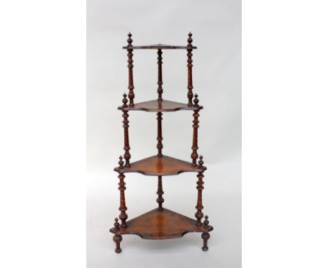 A Victorian mahogany corner shelf, urn finial's over three shelves, with turned twist supports