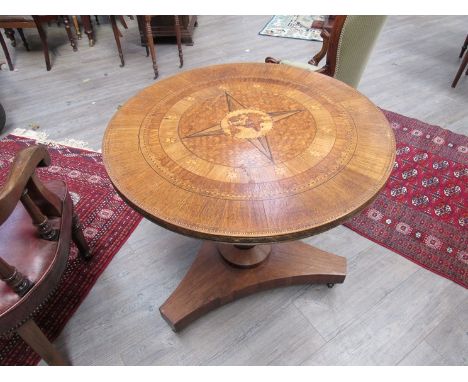 An Irish tilt top breakfast table inlaid with world map and compass points, 83cm diameter top