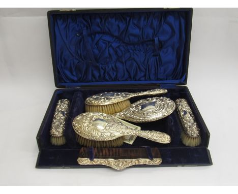 A Joseph and Richard Griffin cased five piece silver dressing table set with embossed floral and swag design, Chester 1908 wi