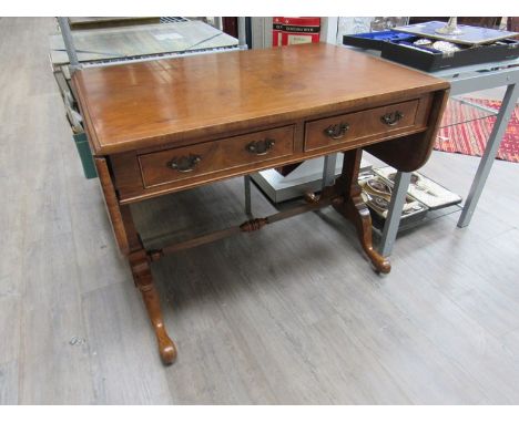 Heal &amp; Son Ltd London a crossbanded figured walnut George III style sofa table, the rising leaves over two frieze and two