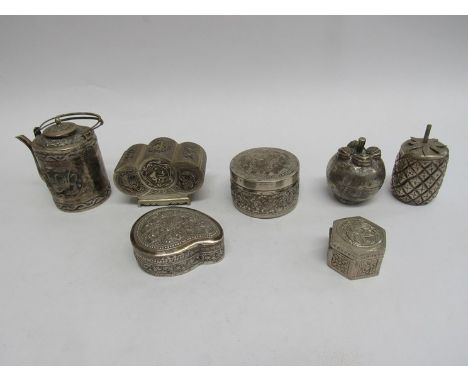 Seven Cambodian white metal ornamental trinket pots including chest form, pineapple and teapot form 