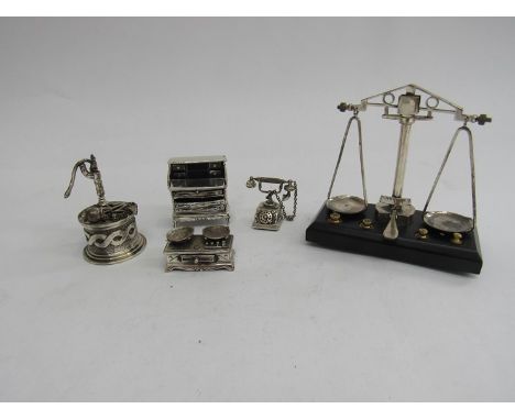 A modern miniature set of balance scales stamped 925, with weights and wooden base, four other similar models, a set of scale