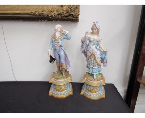 A pair of late 19th/ early 20th Century Continental hand-painted bisque porcelain figures of a gallant and his lady, in early