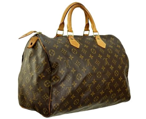 Louis Vuitton Brown Canvas Monogram Speedy 35 Bag. Golden brass hardware, brown interior with slot pocket, vachetta handles. 
