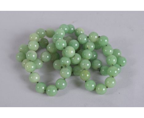 A STRING OF JADE BEADS. 32ins long.