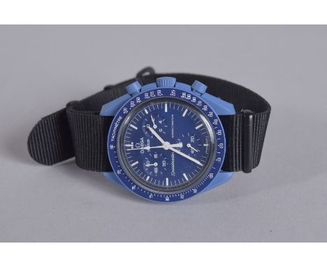 AN OMEGA SWATCH WRIST WATCH with black strap. Speedmaster in a velvet case.