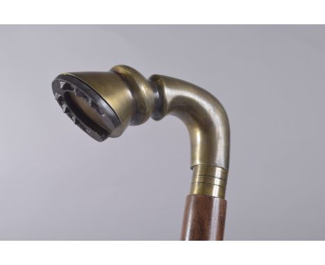A WALKING STICK WITH HORSES HOOF HANDLE.