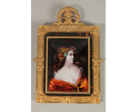 A SUPERB FRENCH LIMOGES ENAMEL PORTRAIT, HEAD AND SHOULDERS OF A YOUNG LADY, 14cms x 10cms, in an ormolu frame 20cms x 16cms.