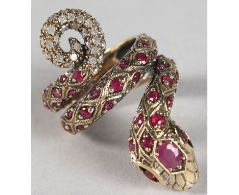 A 9CT GOLD, RUBY AND DIAMOND SET SNAKE RING.