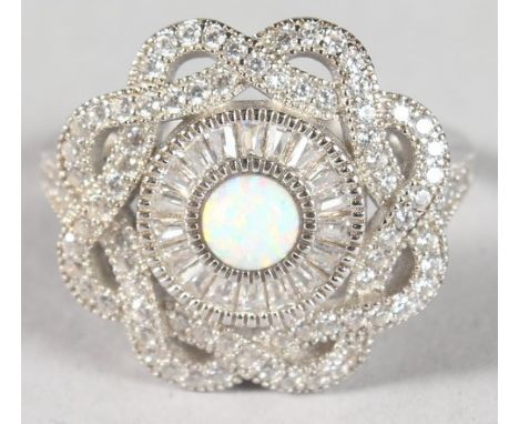 A SILVER CIRCULAR OPAL RING.