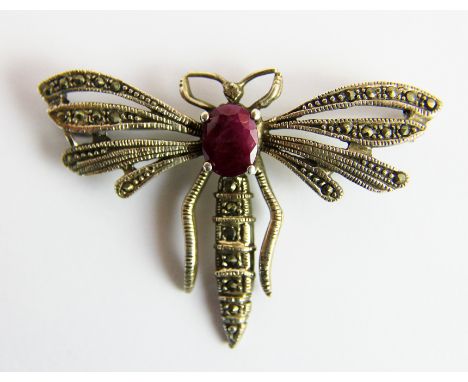 Silver dragonfly brooch set with a large ruby. Wingspan 6 cm.