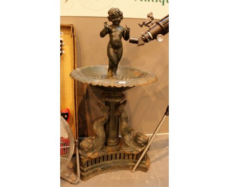 Fountain on heavy cast iron dolphin base featuring mannequin pis