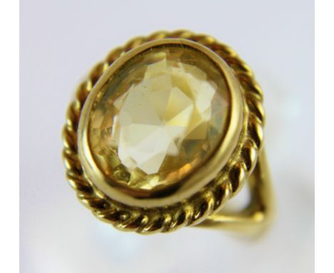 Heavy yellow metal topaz set ring. 5.9g. Size K/L.