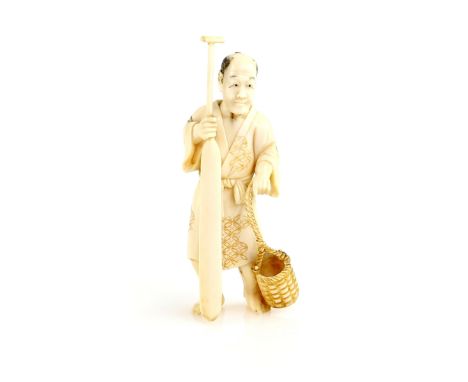 An ivory okimono of a standing boatman, holding a large oar beside a basket, 9.5 cm high, 20th CenturyProvenance: The Propert