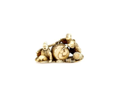 A stained ivory netsuke of two young taiko drummers with a large tomo-e drum, un-signedProvenance: The Property of a Lady. Fr