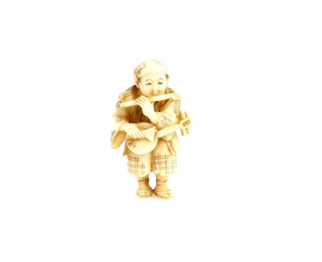 A stained ivory netsuke of a Samisen player with a flute, signed Seigyoku, 20th CenturyProvenance: The Property of a Lady. Fr