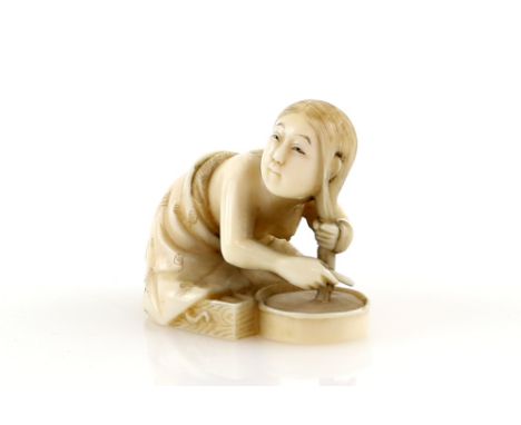 A stained ivory netsuke carved as a girl washing her hair, signed Soshu, 20th CenturyProvenance: The Property of a Lady. From