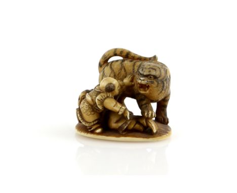 A stained ivory netsuke on oval base with single himotoshi, carved as the boy hero, Yoko and the large tiger, unsigned, Meiji