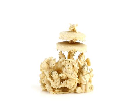 An ivory okimono, carved as a group of six various characters, 6.5 cm wide, 19th or 20th CenturyProvenance: The Property of a