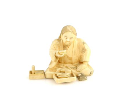 A sectional ivory okimono, carved as a seated artisan holding a sakazuki with his right hand, 6 cm wide, 19th or 20th Century