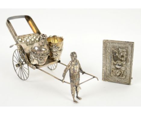 Early 20th century Chinese silver condiment set on stand, comprising salt and pepperette in the form of a man pulling a ricks