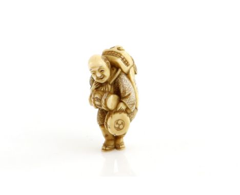 A stained ivory netsuke of a standing shishimai artist, ready to perform with a hand drum for the Spring or Autumn season, 19