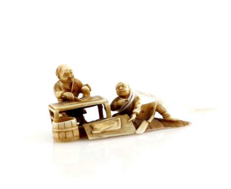 A small ivory okimono, or small netsuke with single himotoshi; carved as two men preparing food, signed Kogyoku, Meiji Period