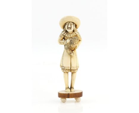 A stained ivory netsuke of a standing Dutchman from Deshima Island in Nagasaki Bay, wearing long hair and a wide-brimmed hat 