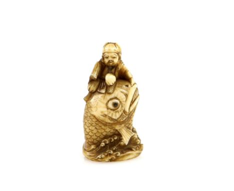 An ivory netsuke carved as Ebisu with a long makemono seated on top of a massive carp, 19th or 20th CenturyProvenance: The Pr