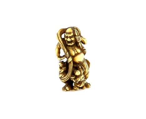 An ivory netsuke of two workmen cleaning a large statue of a Temple Nio, signed NagatsuguProvenance: The Property of a Lady. 