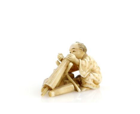 A stained ivory okimono of an umbrella or parasol maker, 5cm long, Meiji PeriodProvenance: The Property of a Lady. From a Pri