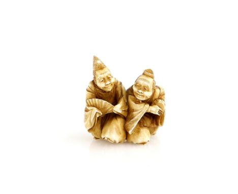 A stained ivory netsuke carved as a pair of Manzai Dancers, 19th or 20th CenturyProvenance: The Property of a Lady. From a Pr
