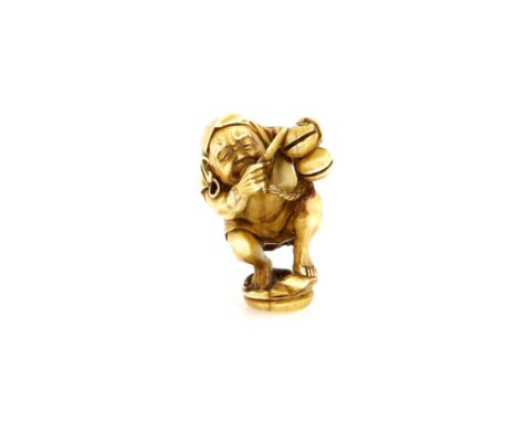 An ivory netsuke of The Bodhisattva Daruma beating a Shinto Suzu (or other percussion) with both handsProvenance: The Propert
