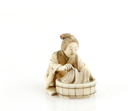 A stained ivory netsuke of  a women beside a circular washing tub;  signed on the base with two kanji, Meiji PeriodProvenance