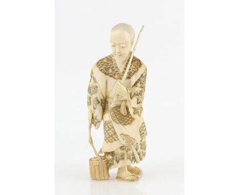 A stained ivory okimono of a fisherman, probably Urashima Taro in old age, holding a basket in the right hand and a fishing r