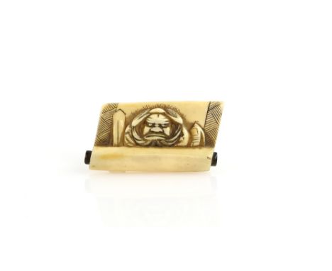 An ivory netsuke of Shoki, The Demon Queller, emerging from a rolled up kakejiku, un-signedProvenance: The Property of a Lady