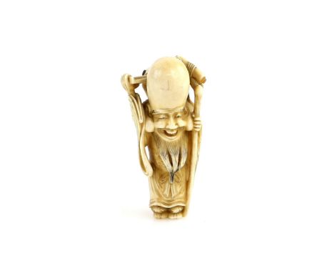 An ivory netsuke of Fukurokuju, holding a staff in his left hand and carrying a child on his back; signed Masakazu, 19th or 2