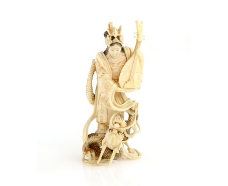 A stained ivory okimono carved as Benten, holding a Biwa and standing on a dragon, 11 cm high, 19th or 20th CenturyProvenance