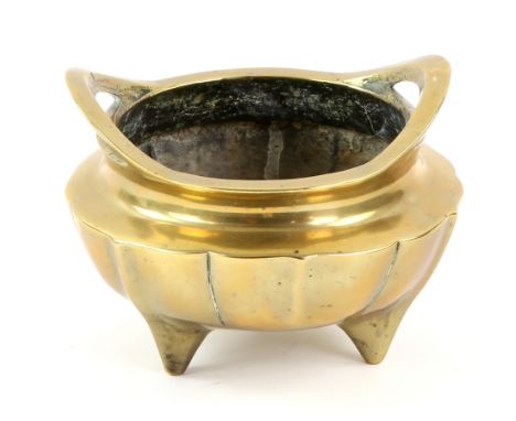 A Chinese metal alloy incense burner on tripod feet with faceted exterior; the base with Xuande six-character mark, but not o