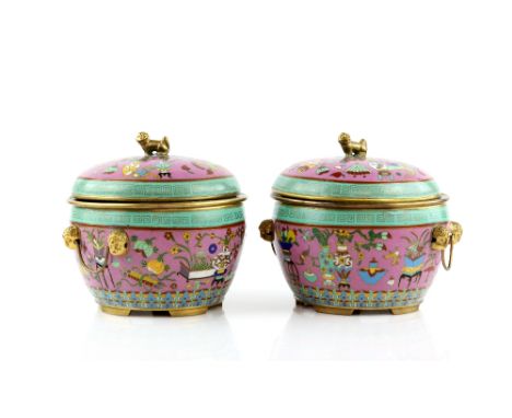 A pair of Chinese cloisonne enamel vessels; each one with domed cover and liner, decorated on the pink-ground exterior with s