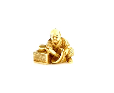 A stained ivory netsuke of a seated artisan with  a bowl, 20th CenturyProvenance: The Property of a Lady. From a Private Coll