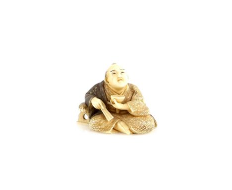 An ivory netsuke of a seated man holding a chawan in his left hand, and a folded fan in his right hand; signed SeishoProvenan